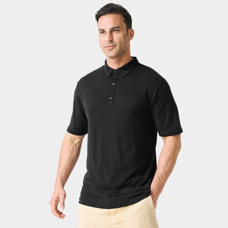Male model wearing white merino wool polo shirt, featuring flexible fit, short sleeves, three-button placket, and stand-up collar for sun protection.
