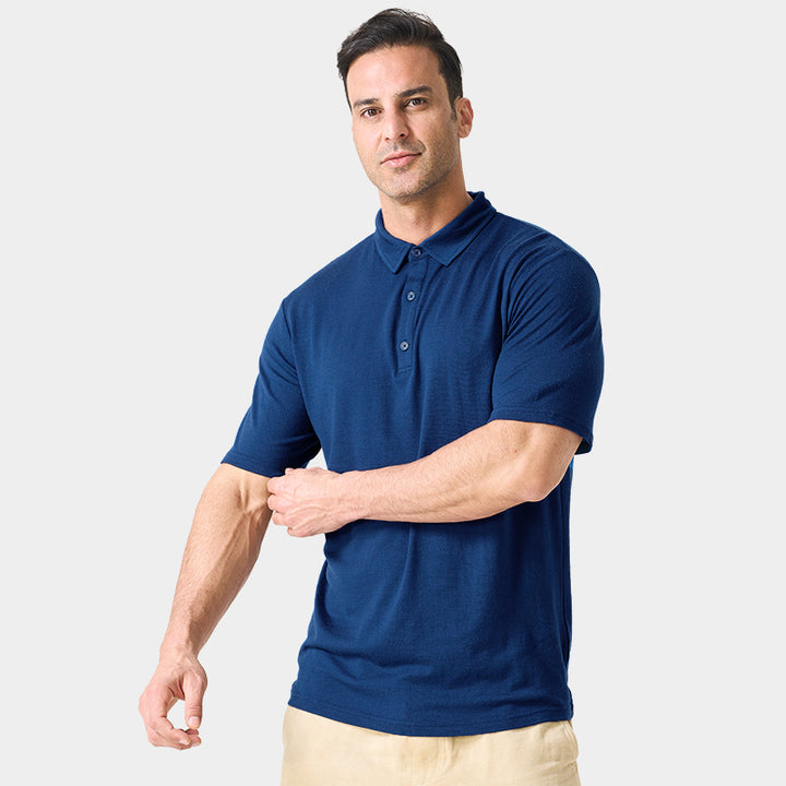 Male model wearing white merino wool polo shirt, featuring flexible fit, short sleeves, three-button placket, and stand-up collar for sun protection.
