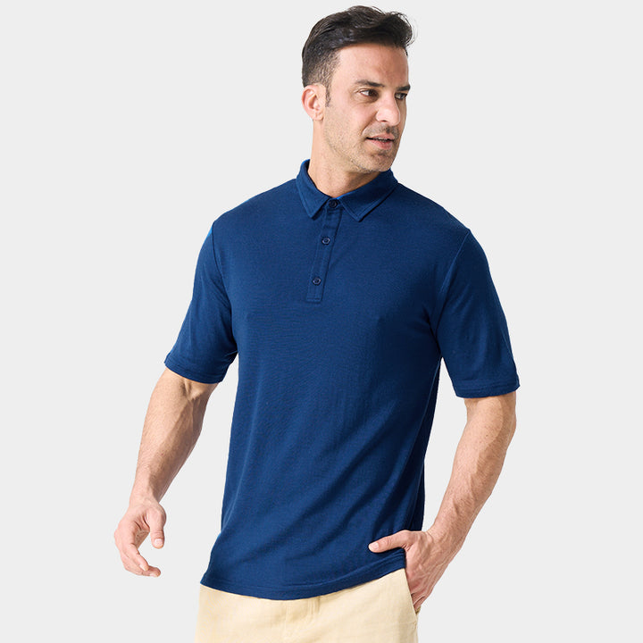 Male model wearing white merino wool polo shirt, featuring flexible fit, short sleeves, three-button placket, and stand-up collar for sun protection.
