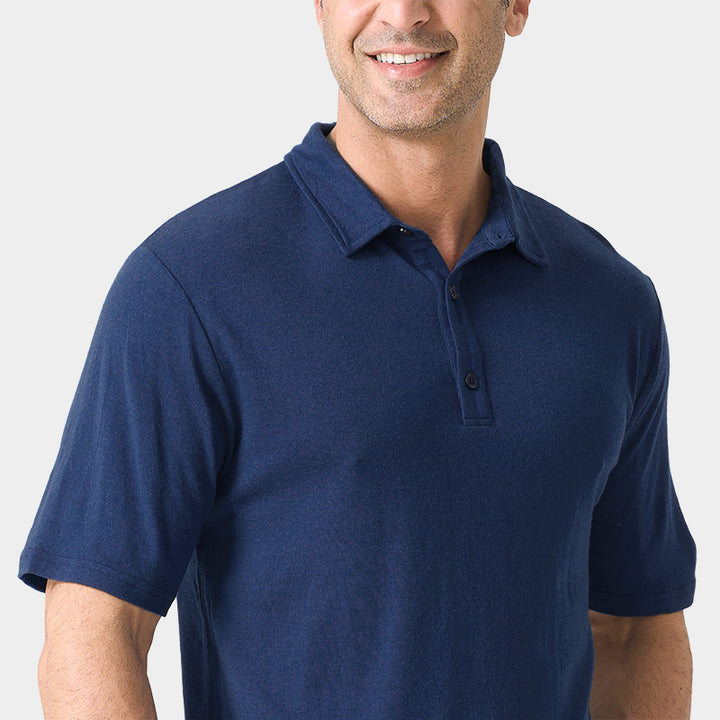 Male model wearing white merino wool polo shirt, featuring flexible fit, short sleeves, three-button placket, and stand-up collar for sun protection.
