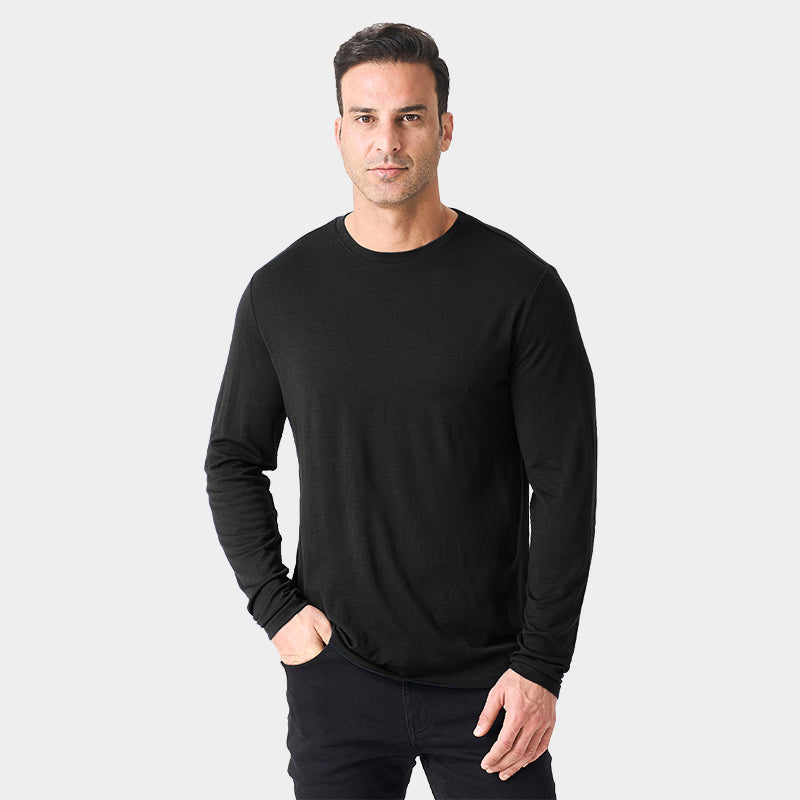Male model wearing a lightweight Merino wool long sleeve crew base layer top, breathable and comfortable, shown in black.