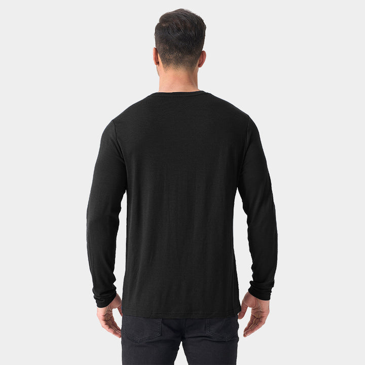 Male model wearing a lightweight Merino wool long sleeve crew base layer top, breathable and comfortable, shown in black.