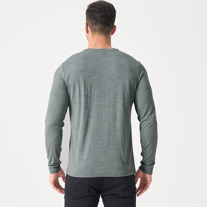 Male model wearing a lightweight Merino wool long sleeve crew base layer top, breathable and comfortable, shown in grey heather.
