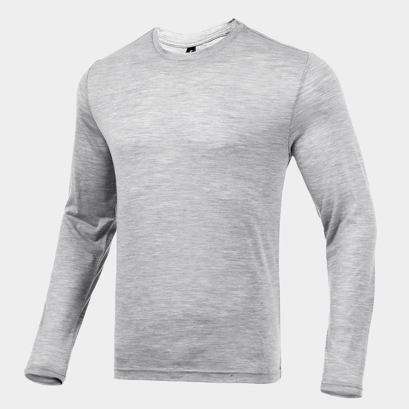 Male model wearing a lightweight Merino wool long sleeve crew base layer top, breathable and comfortable, shown in light grey heather.