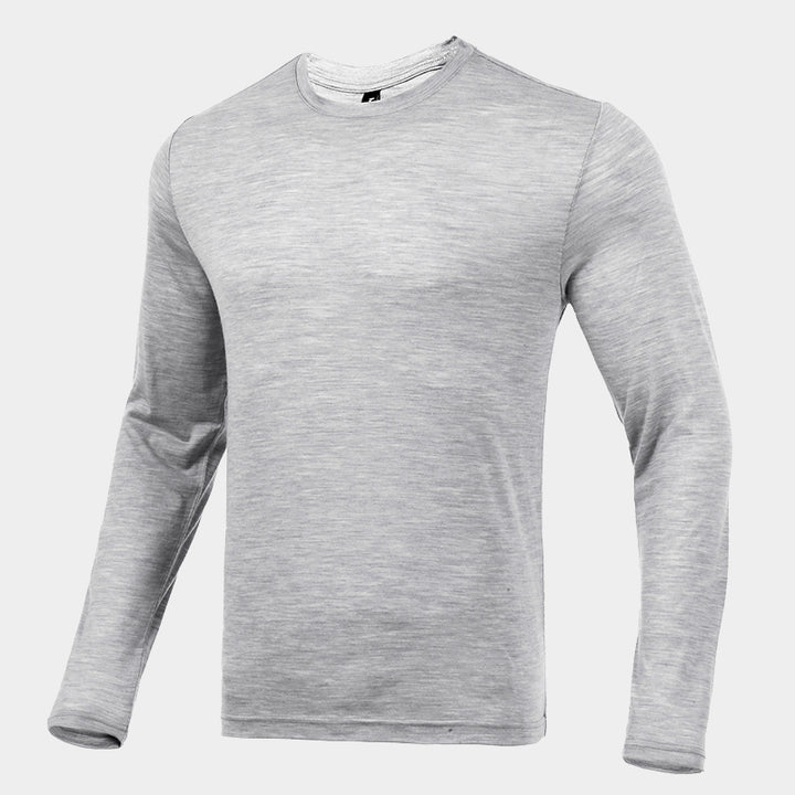 Male model wearing a lightweight Merino wool long sleeve crew base layer top, breathable and comfortable, shown in light grey heather.