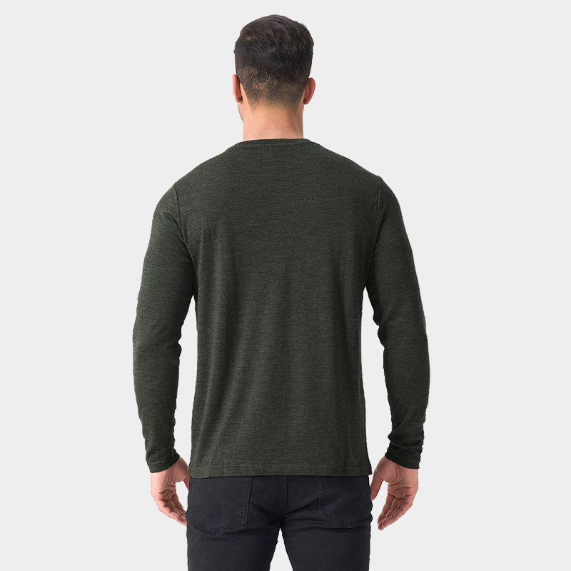 Male model wearing a lightweight Merino wool long sleeve crew base layer top, breathable and comfortable, shown in moss green heather.