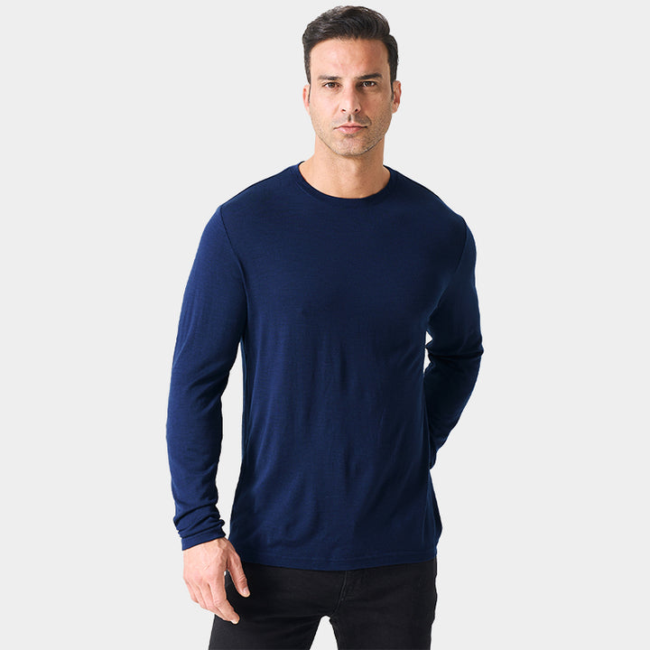Male model wearing a lightweight Merino wool long sleeve crew base layer top, breathable and comfortable, shown in navy.
