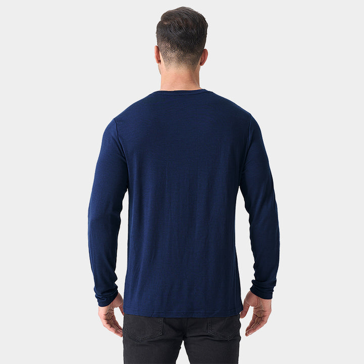 Male model wearing a lightweight Merino wool long sleeve crew base layer top, breathable and comfortable, shown in navy.