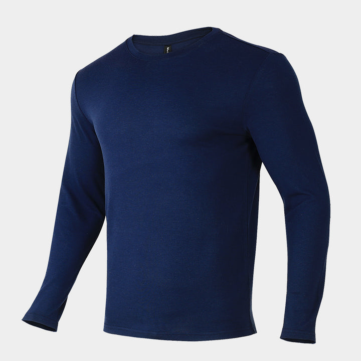 Male model wearing a lightweight Merino wool long sleeve crew base layer top, breathable and comfortable, shown in navy.