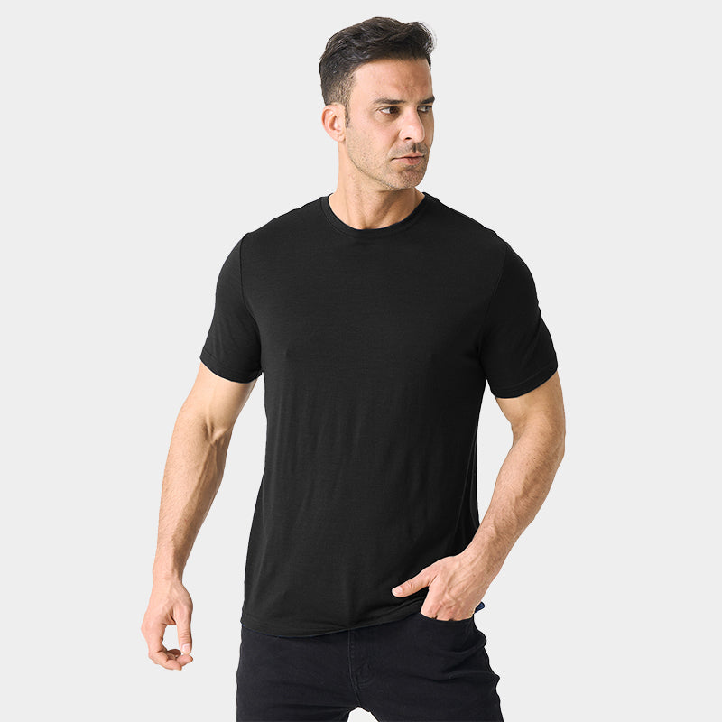 Male model wearing a lightweight Merino wool short sleeve crew t-shirt, breathable and moisture-wicking, shown in Black.