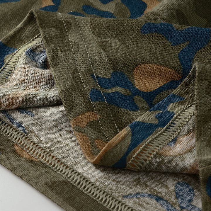 Male model wearing a lightweight Merino wool short sleeve crew t-shirt, breathable and moisture-wicking, shown in camo.