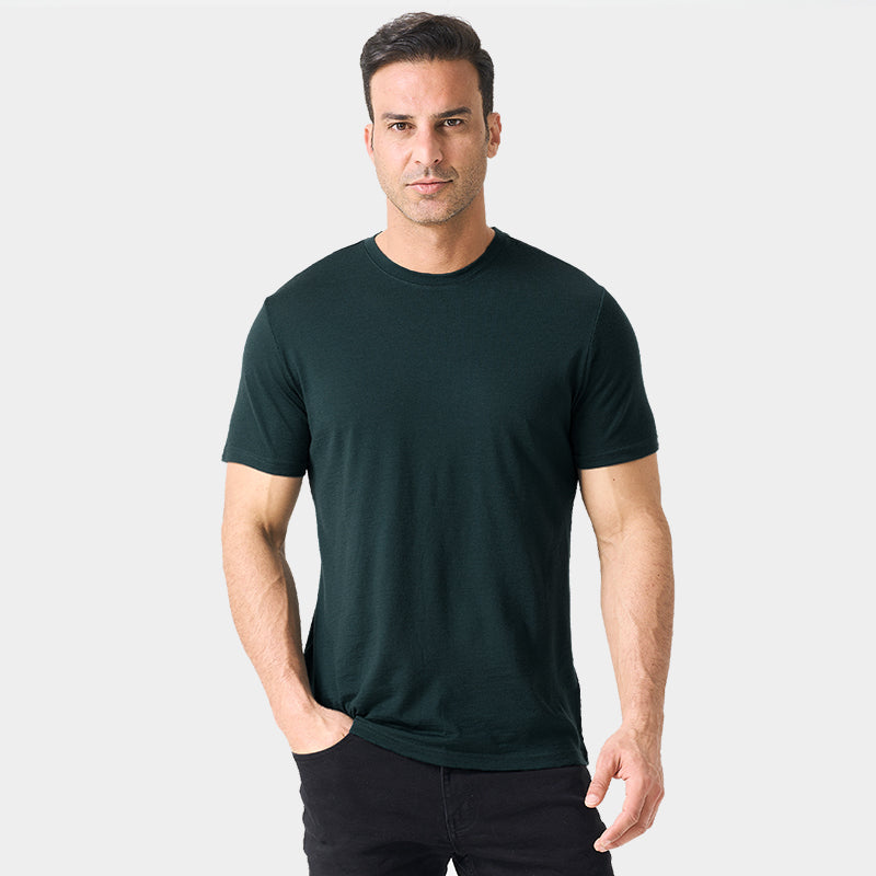 Male model wearing a lightweight Merino wool short sleeve crew t-shirt, breathable and moisture-wicking, shown in dark green.