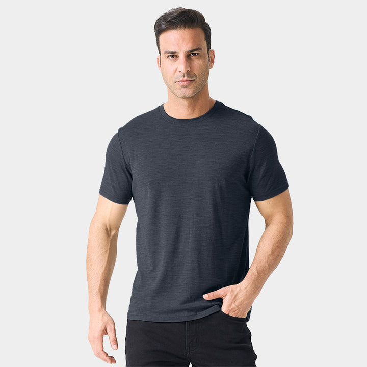 Male model wearing a lightweight Merino wool short sleeve crew t-shirt, breathable and moisture-wicking, shown in dark grey.