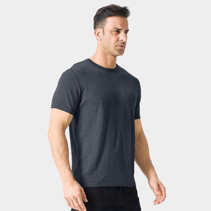 Male model wearing a lightweight Merino wool short sleeve crew t-shirt, breathable and moisture-wicking, shown in dark grey.
