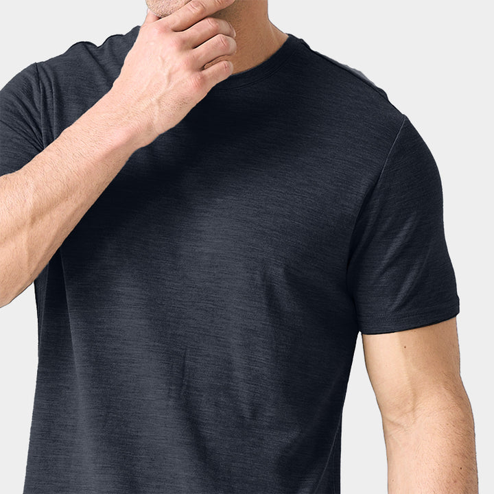 Male model wearing a lightweight Merino wool short sleeve crew t-shirt, breathable and moisture-wicking, shown in dark grey.