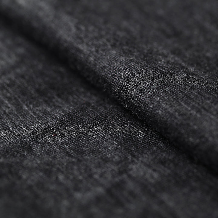 Male model wearing a lightweight Merino wool short sleeve crew t-shirt, breathable and moisture-wicking, shown in dark grey.
