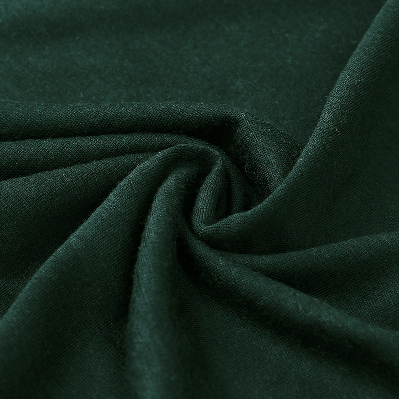 Male model wearing a lightweight Merino wool short sleeve crew t-shirt, breathable and moisture-wicking, shown in forest green.