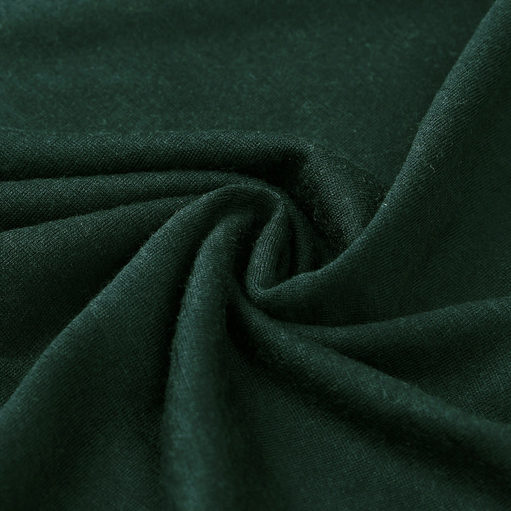 Male model wearing a lightweight Merino wool short sleeve crew t-shirt, breathable and moisture-wicking, shown in forest green.