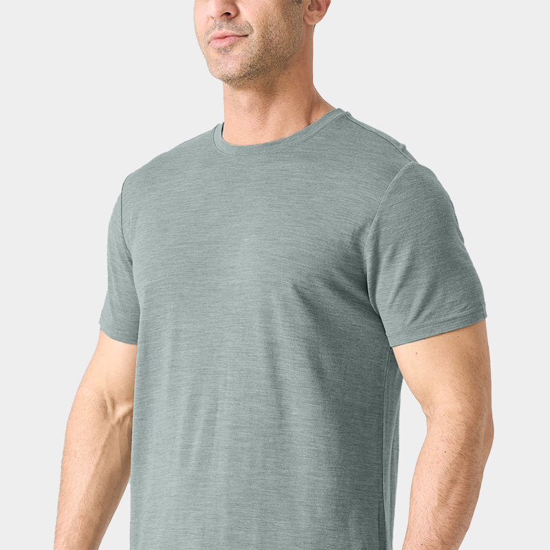 Male model wearing a lightweight Merino wool short sleeve crew t-shirt, breathable and moisture-wicking, shown in grey.
