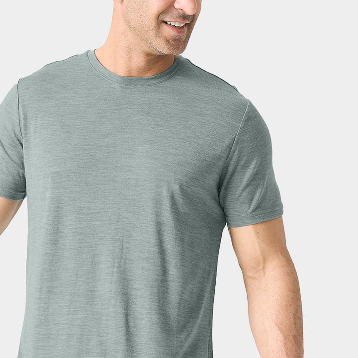 Male model wearing a lightweight Merino wool short sleeve crew t-shirt, breathable and moisture-wicking, shown in grey.