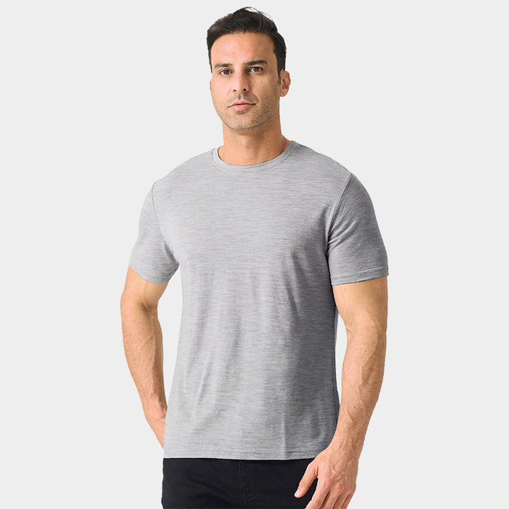 Male model wearing a lightweight Merino wool short sleeve crew t-shirt, breathable and moisture-wicking, shown in light grey.