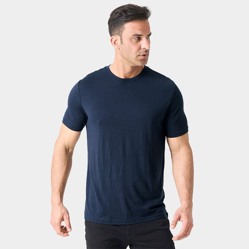 Male model wearing a lightweight Merino wool short sleeve crew t-shirt, breathable and moisture-wicking, shown in navy.