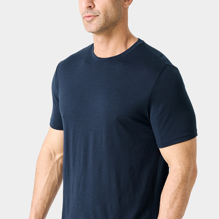 Male model wearing a lightweight Merino wool short sleeve crew t-shirt, breathable and moisture-wicking, shown in navy.