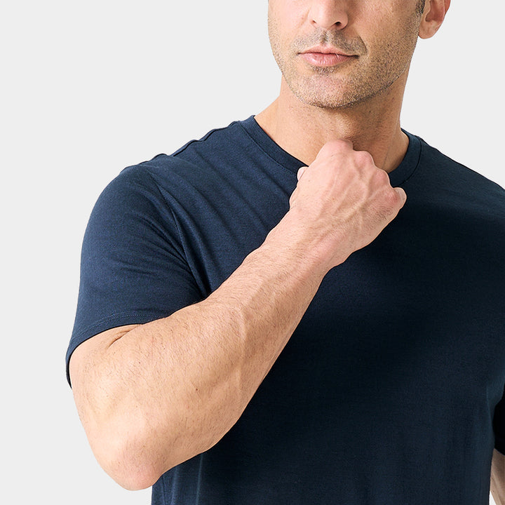 Male model wearing a lightweight Merino wool short sleeve crew t-shirt, breathable and moisture-wicking, shown in navy.