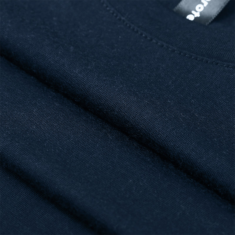 Male model wearing a lightweight Merino wool short sleeve crew t-shirt, breathable and moisture-wicking, shown in navy.