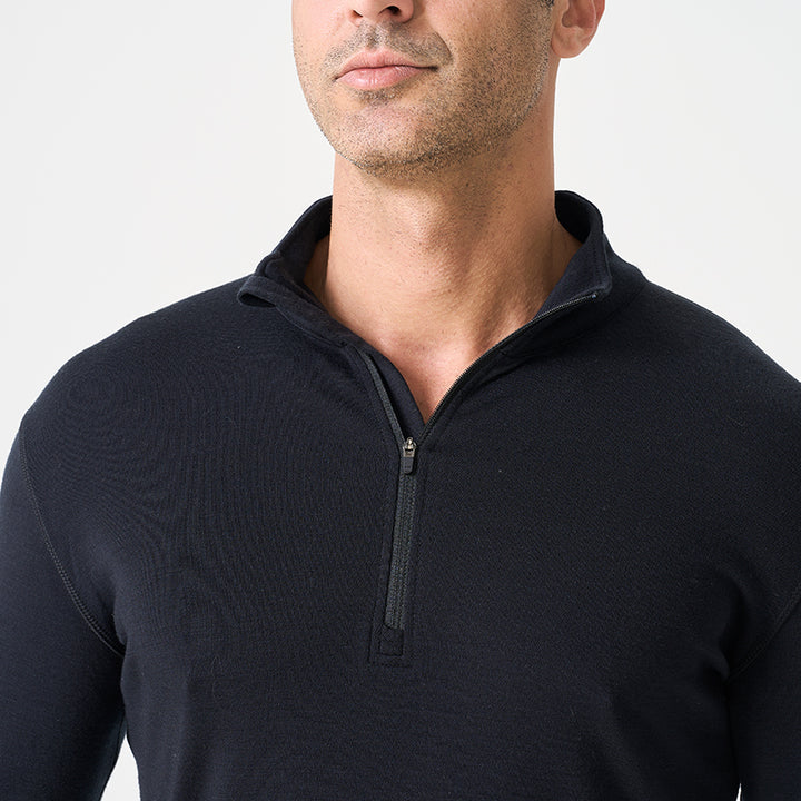 Male model wearing black Men’s 250g Merino wool long sleeve half zip top, breathable and moisture-wicking for warmth and outdoor comfort.