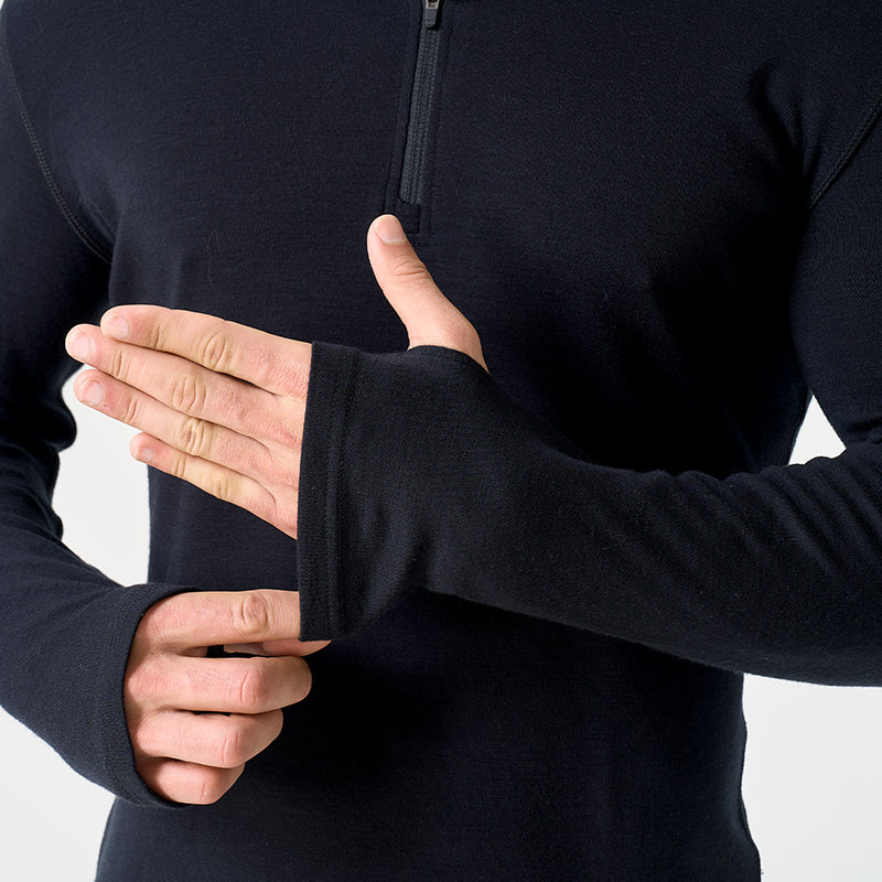 Male model wearing black Men’s 250g Merino wool long sleeve half zip top, breathable and moisture-wicking for warmth and outdoor comfort.