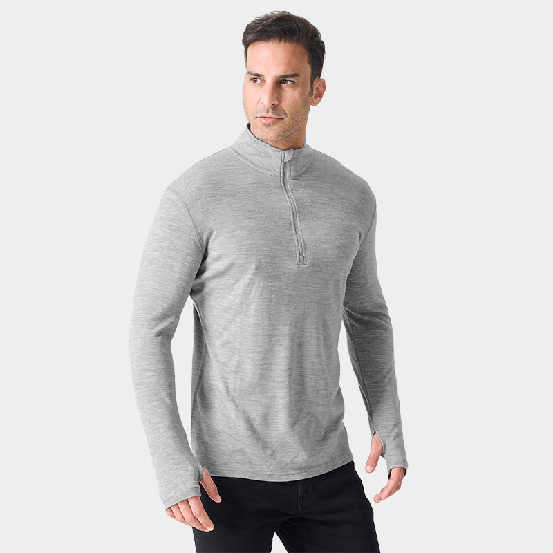 Male model wearing Light Grey Heather Men’s 250g Merino wool long sleeve half zip top, breathable and moisture-wicking for warmth and outdoor comfort.