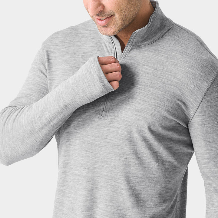 Male model wearing Light Grey Heather Men’s 250g Merino wool long sleeve half zip top, breathable and moisture-wicking for warmth and outdoor comfort.