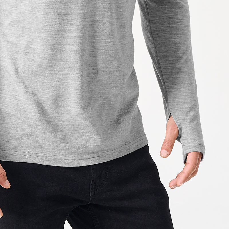 Male model wearing Light Grey Heather Men’s 250g Merino wool long sleeve half zip top, breathable and moisture-wicking for warmth and outdoor comfort.