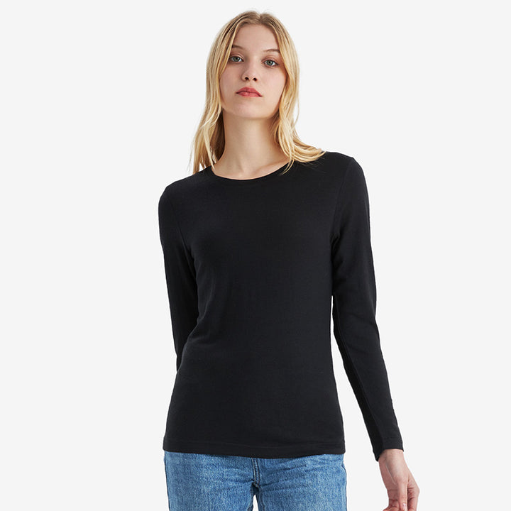Famel model wearing a lightweight Merino wool long sleeve crew base layer top, breathable and comfortable, shown in black.