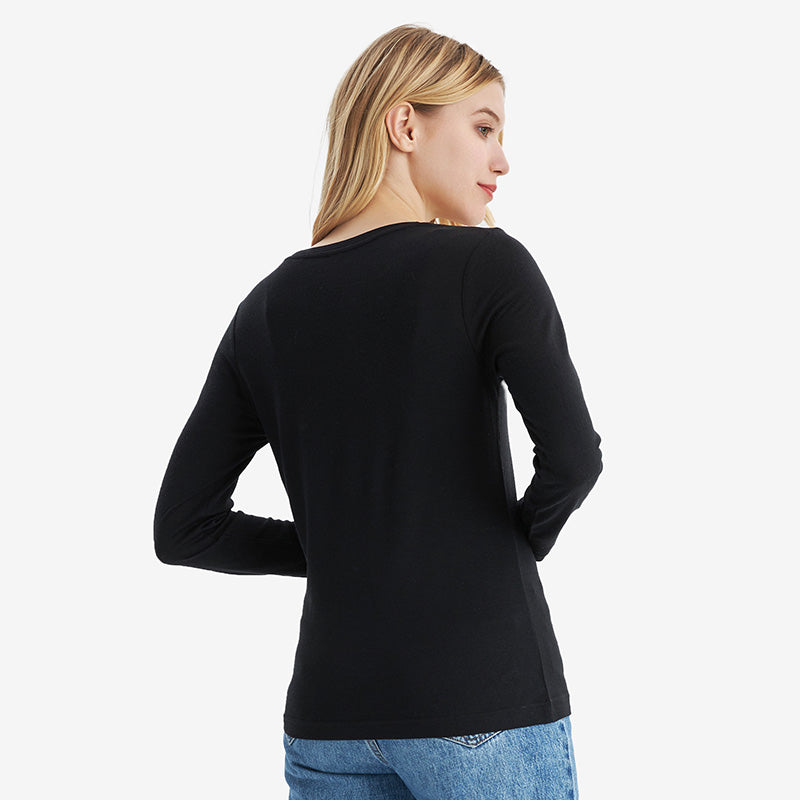 Famel model wearing a lightweight Merino wool long sleeve crew base layer top, breathable and comfortable, shown in black.