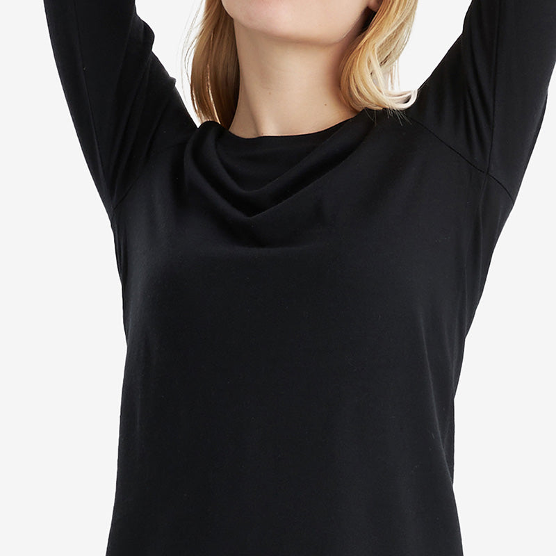 Famel model wearing a lightweight Merino wool long sleeve crew base layer top, breathable and comfortable, shown in black.