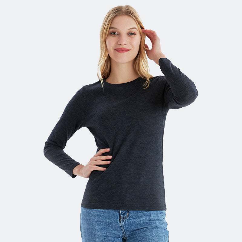 Famel model wearing a lightweight Merino wool long sleeve crew base layer top, breathable and comfortable, shown in black heather.