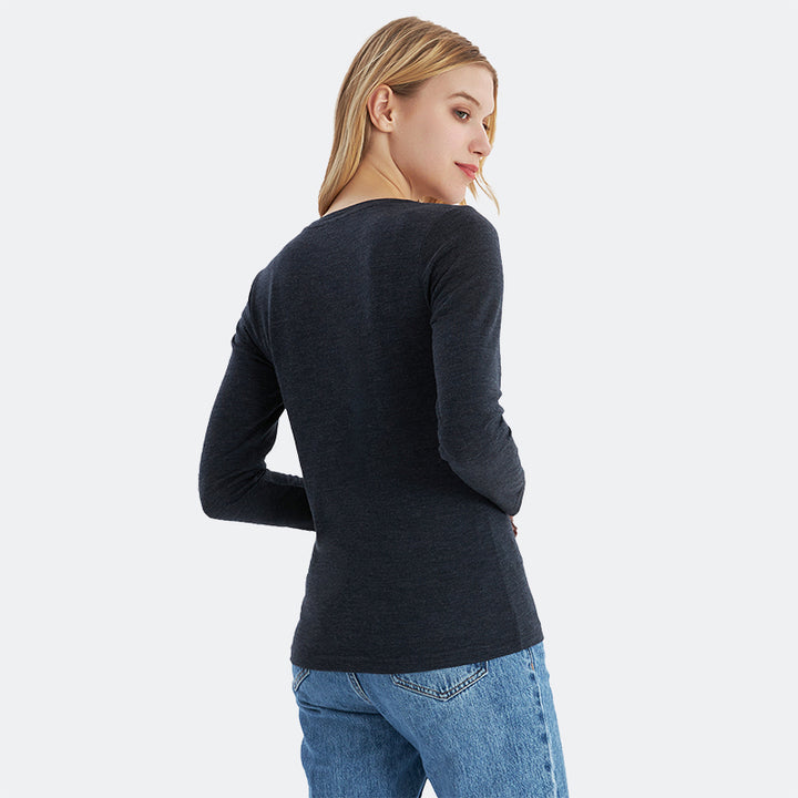 Famel model wearing a lightweight Merino wool long sleeve crew base layer top, breathable and comfortable, shown in black heather.