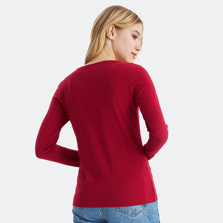 Famel model wearing a lightweight Merino wool long sleeve crew base layer top, breathable and comfortable, shown in crimson red heather.