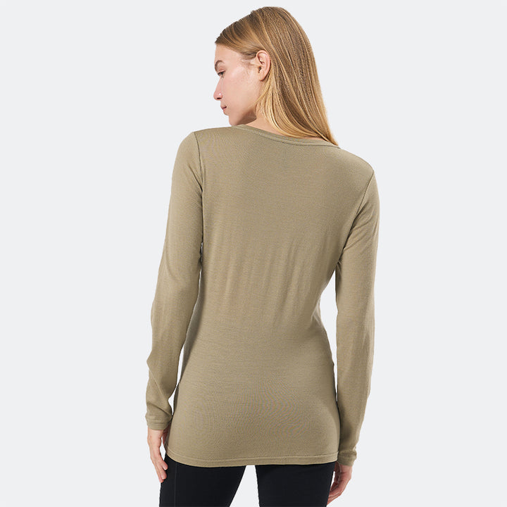 Famel model wearing a lightweight Merino wool long sleeve crew base layer top, breathable and comfortable, shown in dark olive.