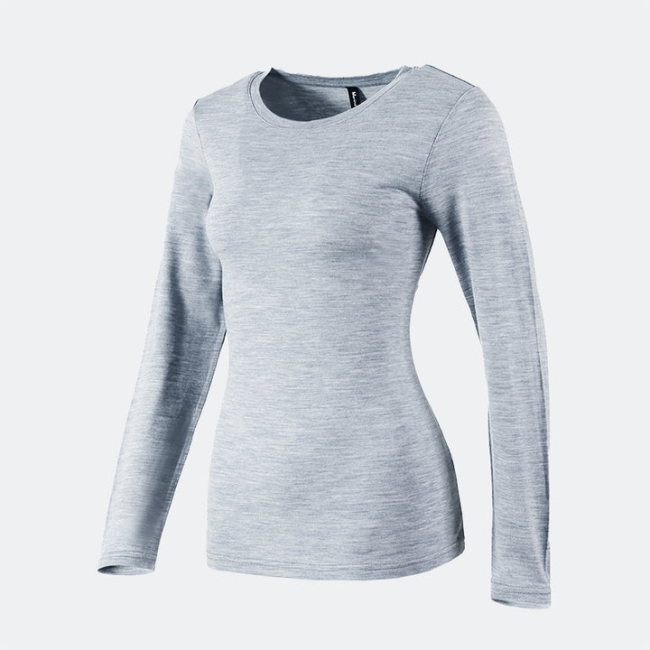 Famel model wearing a lightweight Merino wool long sleeve crew base layer top, breathable and comfortable, shown in grey heather.