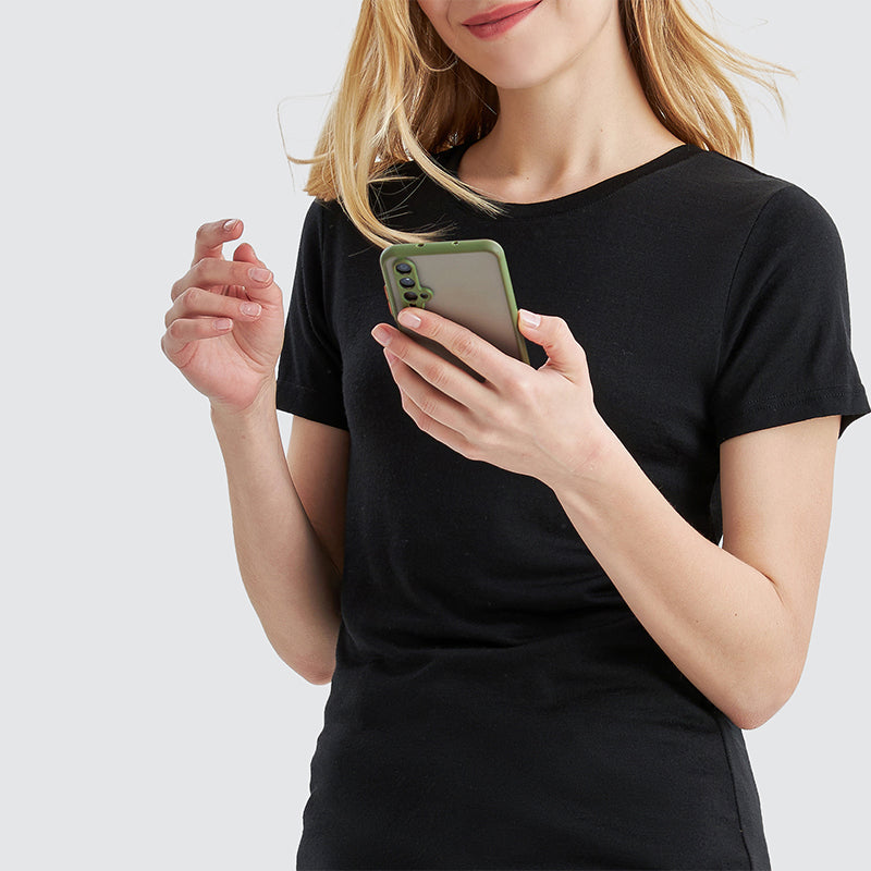 Famel model wearing a lightweight Merino wool short sleeve crew t-shirt, breathable and comfortable, shown in black.
