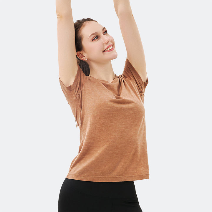 Famel model wearing a lightweight Merino wool short sleeve crew t-shirt, breathable and comfortable, shown in caramel.