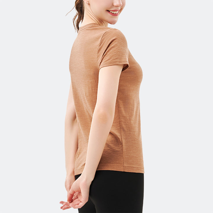 Famel model wearing a lightweight Merino wool short sleeve crew t-shirt, breathable and comfortable, shown in caramel.