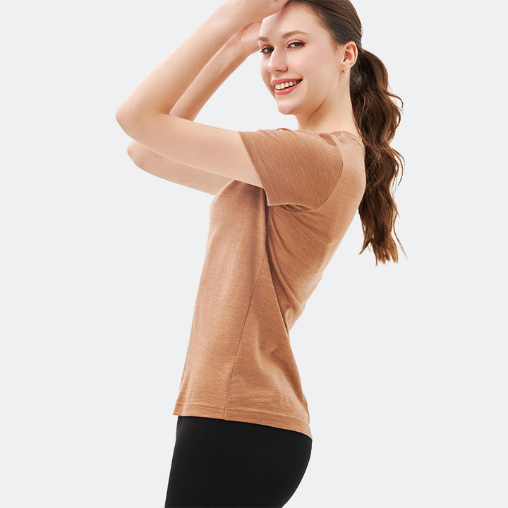 Famel model wearing a lightweight Merino wool short sleeve crew t-shirt, breathable and comfortable, shown in caramel.