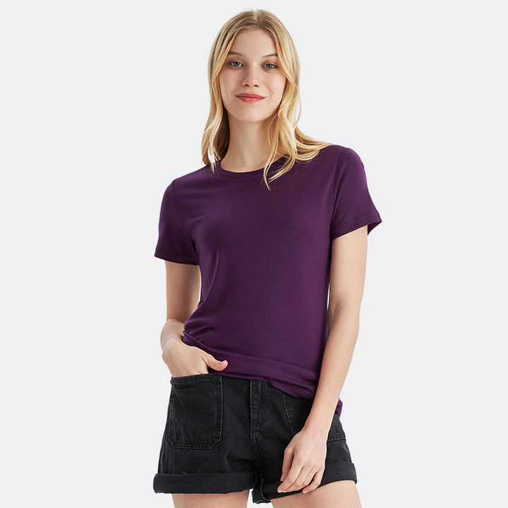 Famel model wearing a lightweight Merino wool short sleeve crew t-shirt, breathable and comfortable, shown in dark purple.
