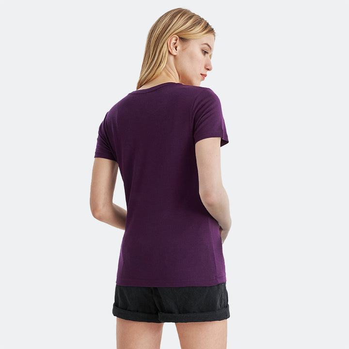 Famel model wearing a lightweight Merino wool short sleeve crew t-shirt, breathable and comfortable, shown in dark purple.