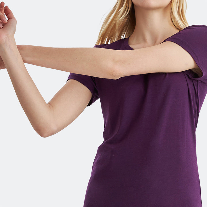 Famel model wearing a lightweight Merino wool short sleeve crew t-shirt, breathable and comfortable, shown in dark purple.