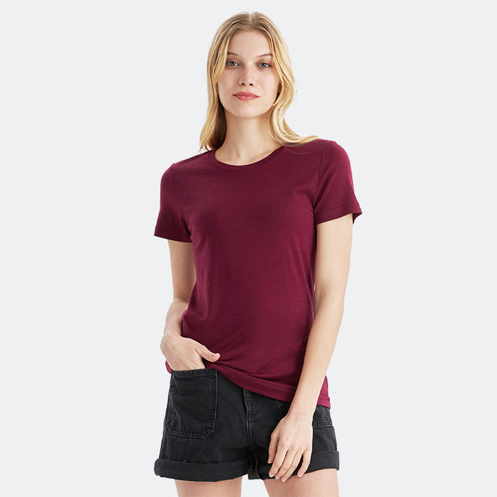 Famel model wearing a lightweight Merino wool short sleeve crew t-shirt, breathable and comfortable, shown in dark red.
